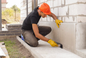 Construction worker repair home foundation